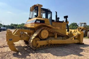Crawler bulldozer pushing soil on construction site