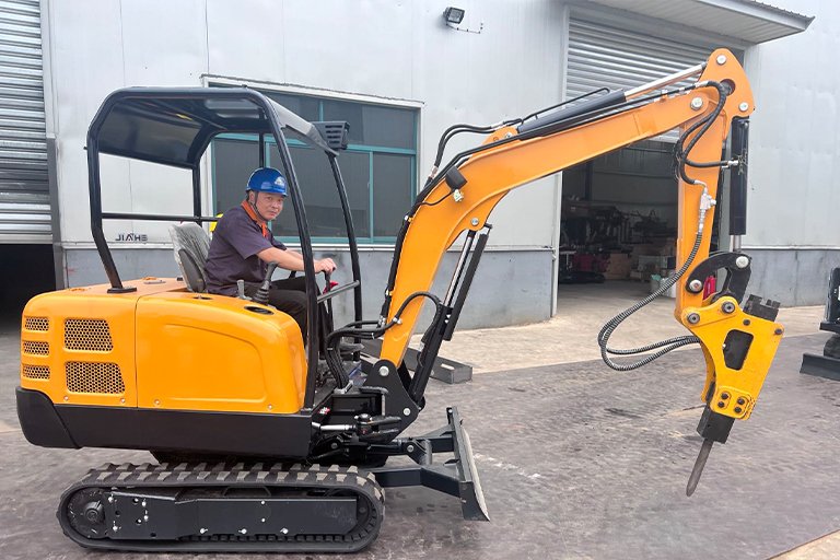 Mini excavator with hydraulic breaker attachment used for concrete demolition